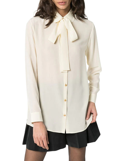 Silk shirt with bow by Gucci.