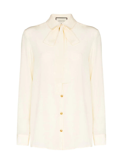 Silk shirt with bow by Gucci.